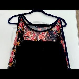 This shirt is a women’s extra large with a beautiful flower print on the sleeve